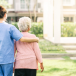A nurse taking care of an elderly woman patient.